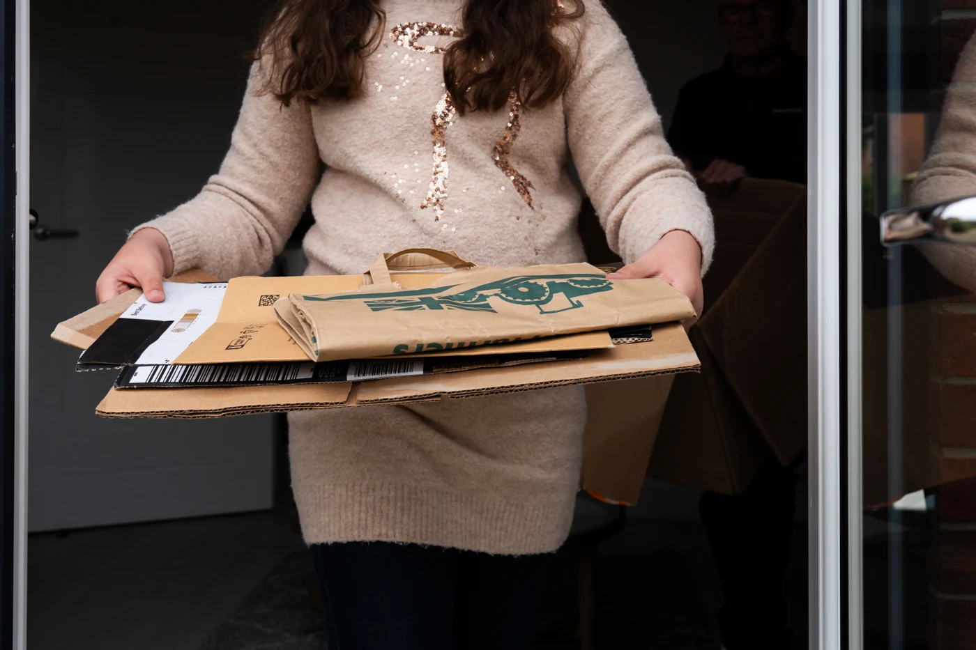 Flattened cardboard boxes held in a neat stack.